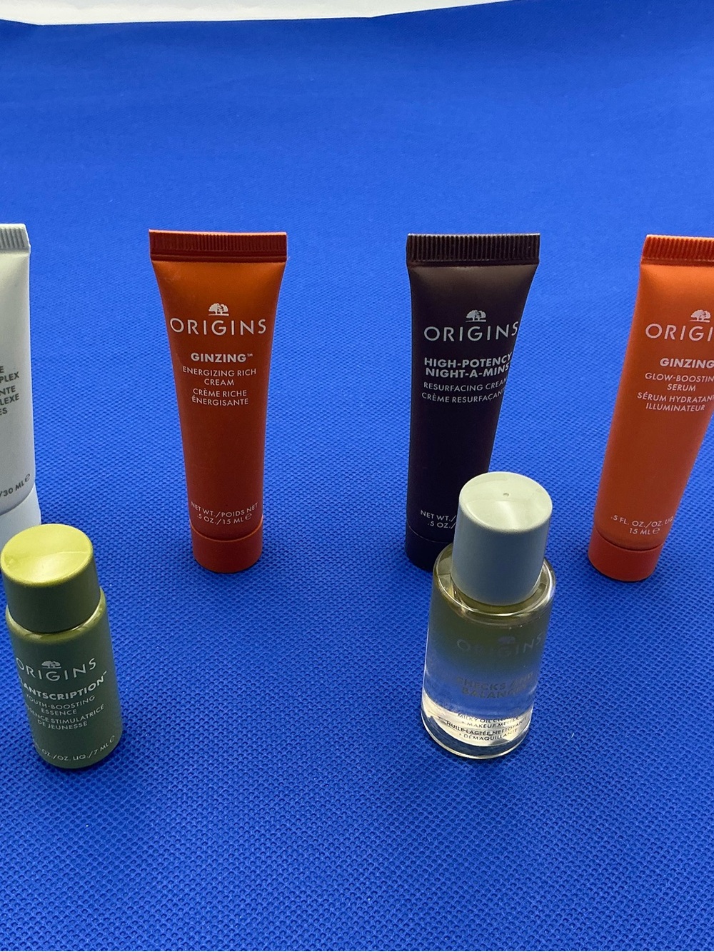 Origins skincare set with orange, green, purple, clear bottles